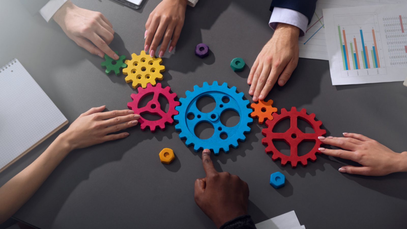 Business team connect pieces of gears. Teamwork, partnership and integration concept