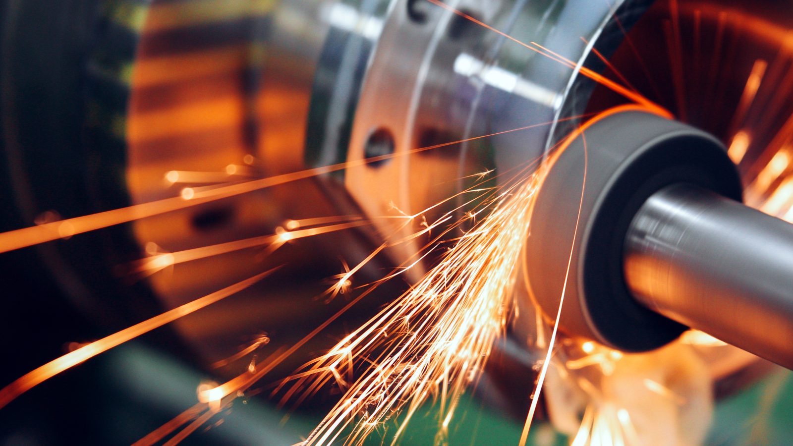 sparks flying while machine griding and finishing metal