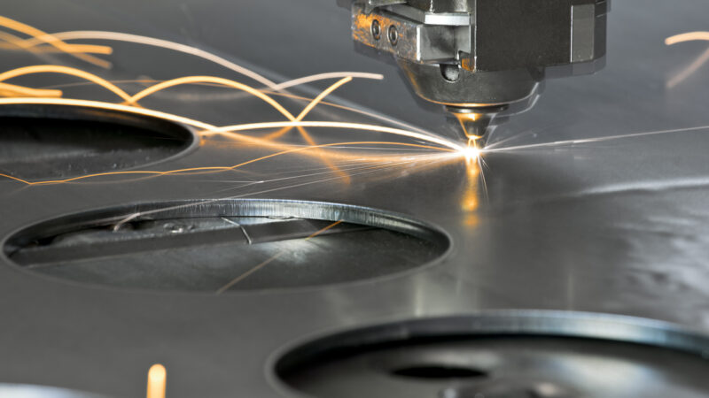 Laser metal cutting manufacturing tool in operation.