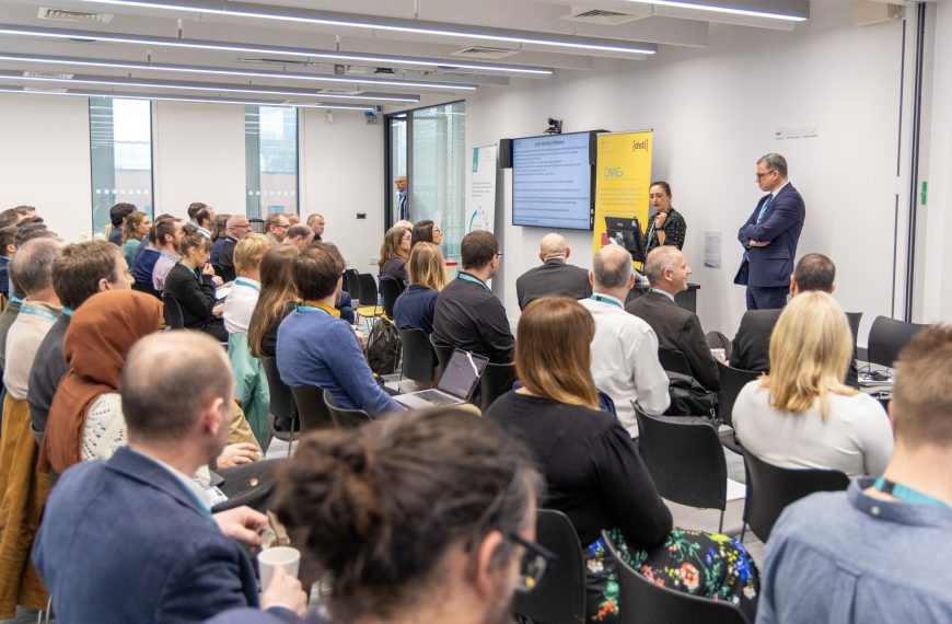 Event attendees watching a seminar in the Royce Hub Building meeting rooms