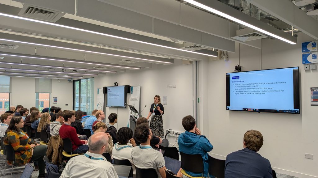 A crowd of event attendees watching a speaker at the UK Metamaterials Summer School 2025